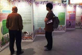 The photo shows visitors viewing exhibition panels at the roving exhibition to gain a better understanding of the Ordinance.